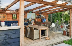 a wooden pergola with a table and chairs on a deck at Nice Home In Sint-oedenrode With Wifi in Sint-Oedenrode