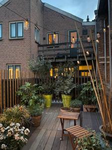 a patio with plants and a building with a balcony at City-beach apartment nearby Amsterdam in Hoorn