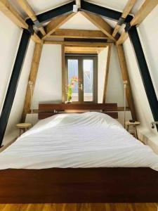 a large bed in a room with a window at City-beach apartment nearby Amsterdam in Hoorn +32 photos