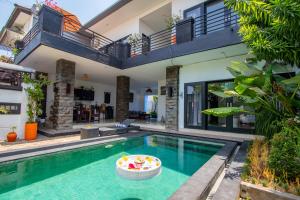 a villa with a swimming pool and a house at Sunbeji - Relax and Unwind - Seminyak Luxury Stay with Private Pool in Seminyak