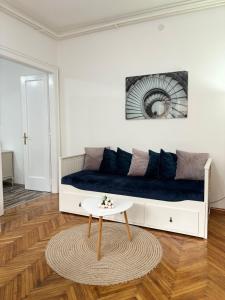 a living room with a couch and a table at Center Retro Apartment in Niš