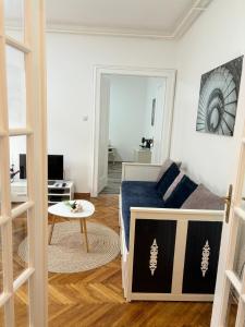 a bedroom with a bed and a table in a room at Center Retro Apartment in Niš