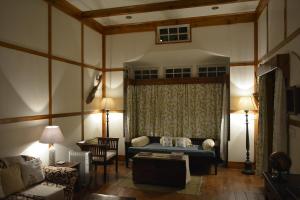 a living room with a couch and a table at Cafe Shillong Bed and Breakfast in Shillong