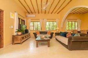 a living room with a couch and a table at Allamanda Villa by YourHost, 10 bedroom, Malindi in Malindi