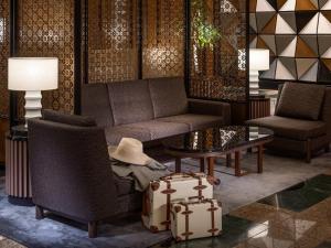 a living room with a couch and a table and luggage at Hotel The Celestine Tokyo Shiba in Tokyo