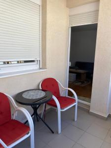 a room with two chairs and a table and a window at Apartman CENTAR in Trebinje