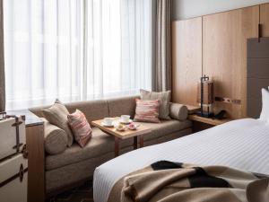 a hotel room with a couch and a bed at Hotel The Celestine Tokyo Shiba in Tokyo