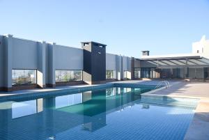 a building with a swimming pool in front of it at Ubatuba North Shore in Ubatuba