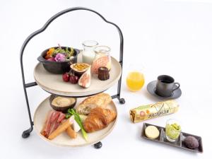 a tray of food on two levels with a plate of food at Hotel The Celestine Tokyo Shiba in Tokyo