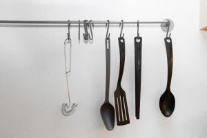 a group of utensils hanging on a wall at 400 meter til Åen - Moderne og fuldt udstyret in Aarhus