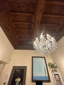 a chandelier hanging from a ceiling in a room at In Centro Lovely Home in Lucca