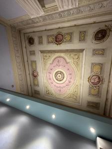 a ceiling in a building with a pink at In Centro Lovely Home in Lucca