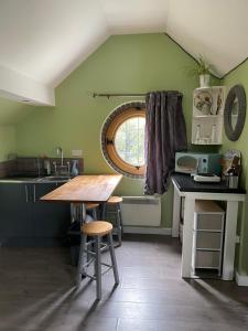 a kitchen with a wooden table and a window at The Loft 