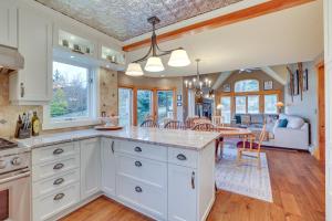 a kitchen with white cabinets and a dining room at Ski-In and Ski-Out Townhome in Jay Peak Ski Resort! in Jay