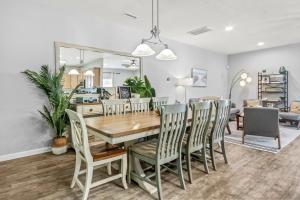 a dining room and living room with a table and chairs at Alohalani at Surfside Beach in Myrtle Beach