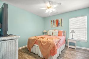 a bedroom with a bed and a ceiling fan at Alohalani at Surfside Beach in Myrtle Beach