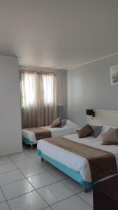 Postel nebo postele na pokoji v ubytování Hotel Restaurant Miramar L'orchidée