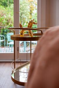 a table with a statue of a horse on it at Primrose Hill Apartments in London