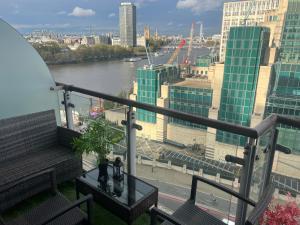 a balcony with a view of a river and buildings at St George Thames Apartment in London