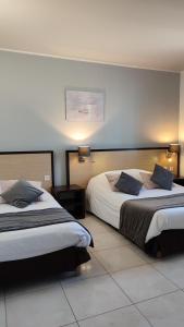 Postel nebo postele na pokoji v ubytování Hotel Restaurant Miramar L'orchidée