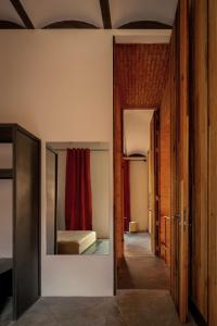 a hallway with a room with a bed and a mirror at Otro Oaxaca, a Member of Design Hotels in Oaxaca City