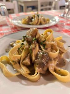 a plate of pasta with meat and sauce on a table at Sunset le Sirene in Scilla