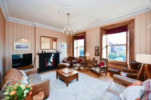 a living room filled with furniture and a fireplace at Pladda View in Ayr