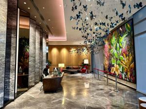 a lobby with a large painting of butterflies on the wall at Viia@Eco kl city#Mid Velly in Kuala Lumpur