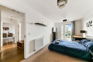 a bedroom with a bed and a desk in it at Amazing 2 bed 2 bath flat in Canary Wharf in London