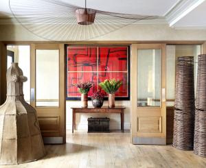 a lobby with wooden doors and a table with flowers at Knightsbridge Hotel, Firmdale Hotels in London