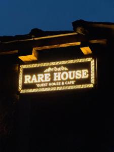 a sign for aire house guest house and cafe at Rare House in Kalgha