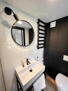 a bathroom with a sink and a mirror at Amsterdam Beach House in Zandvoort