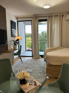 a hotel room with a bed and a balcony at Atelier 35 Studio in Zagreb