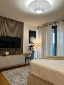 a bedroom with a bed and a flat screen tv at Atelier 35 Studio in Zagreb