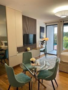 a living room with a bed and a table and chairs at Atelier 35 Studio in Zagreb