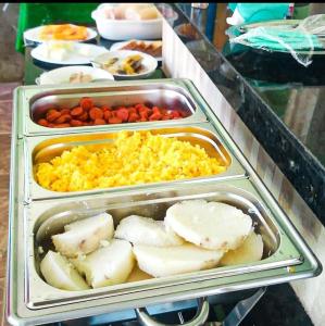 a tray of food with scrambled eggs and potatoes at Pousada Nossa Senhora Das Dores in Maragogi
