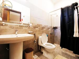 a bathroom with a sink and a toilet and a shower at Grand Peace House I in Islamabad