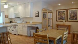 a kitchen with a wooden table and a dining room at Street South House #54587 in Bradenton Beach