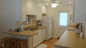 a kitchen with white cabinets and a white refrigerator at Street South House #54587 in Bradenton Beach