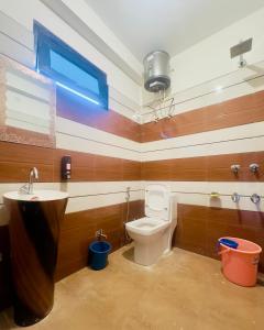 a bathroom with a toilet and a sink at Rare House in Kalgha