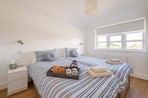 a bedroom with a bed with a tray of fruit on it at Fisherman's Croft Your Dream Getaway Awaits in Pevensey
