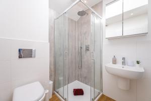 a bathroom with a shower and a toilet and a sink at Fisherman's Croft Your Dream Getaway Awaits in Pevensey
