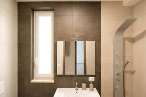 a bathroom with a sink and a mirror at Dimora Rosselli - Apartments in Fasano +59 photos