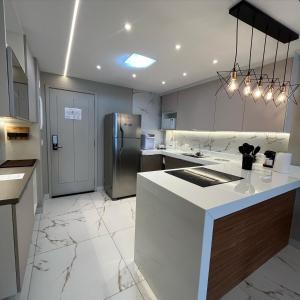 a kitchen with a refrigerator and a counter top at Apartamento Vista.Rio in Niterói