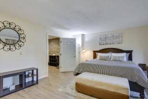 a bedroom with a bed and a mirror on the wall at Modern Vernon Township Condo Near Ski and Water Park in Vernon Township