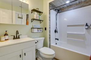 a bathroom with a toilet and a sink and a bath tub at Modern Vernon Township Condo Near Ski and Water Park in Vernon Township +29 photos