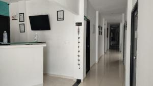 a hallway of a hospital with a tv on the wall at Hotel Bellagio in Barrancabermeja