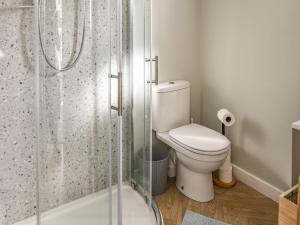 a bathroom with a toilet and a shower at Marnie's Rest in Lyme Regis +16 photos