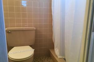 a bathroom with a toilet with a shower curtain at North Shore Duplex #54588 Duplex in Anna Maria
