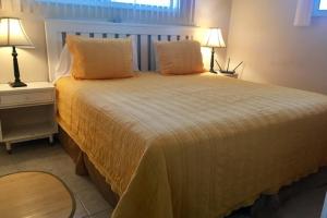 a bedroom with a large bed with two lamps at North Shore Duplex #54588 Duplex in Anna Maria